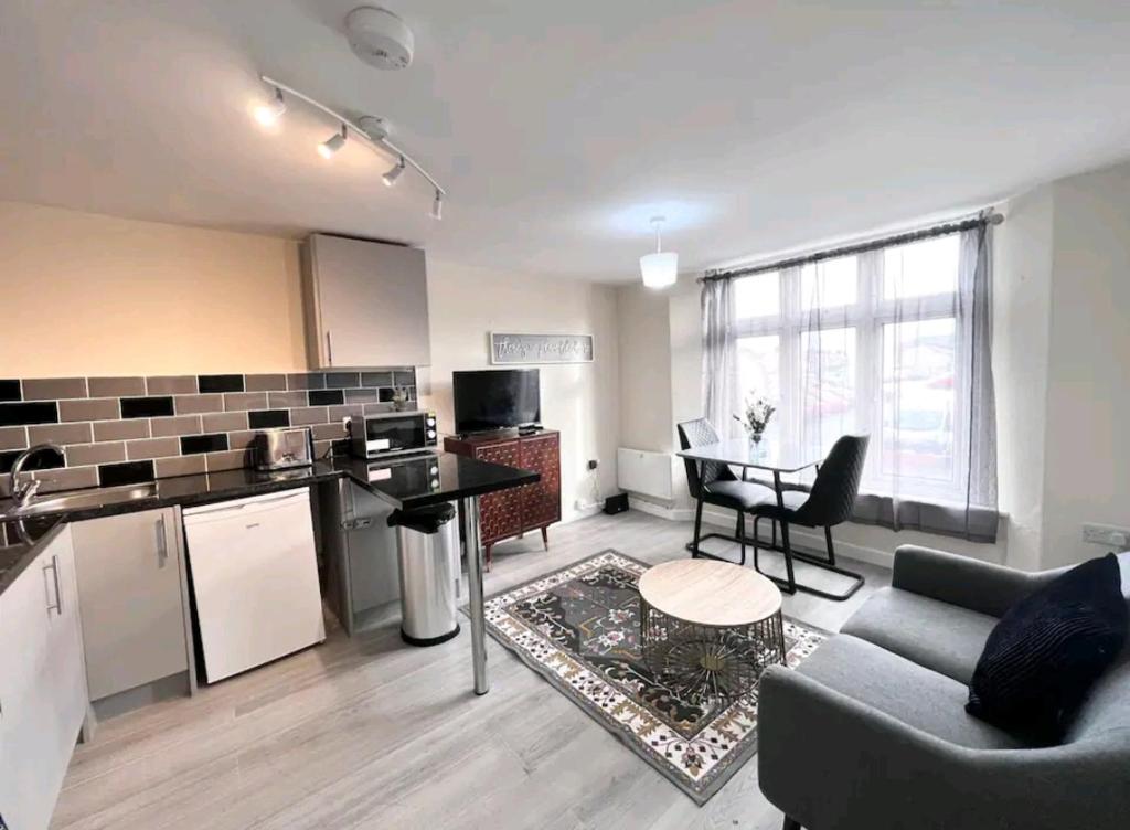 a kitchen and living room with a couch and a table at Taunton Flats in Taunton