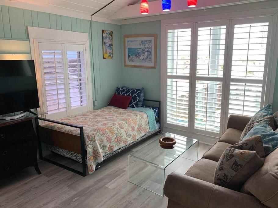 a living room with a bed and a couch at Bayside Cottage in Clearwater Beach