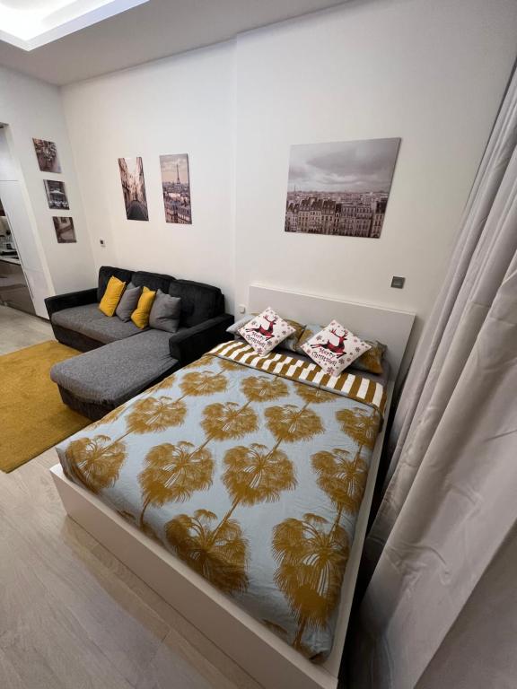 a bedroom with a bed and a couch at Modern Studio Center of Dubai in Dubai