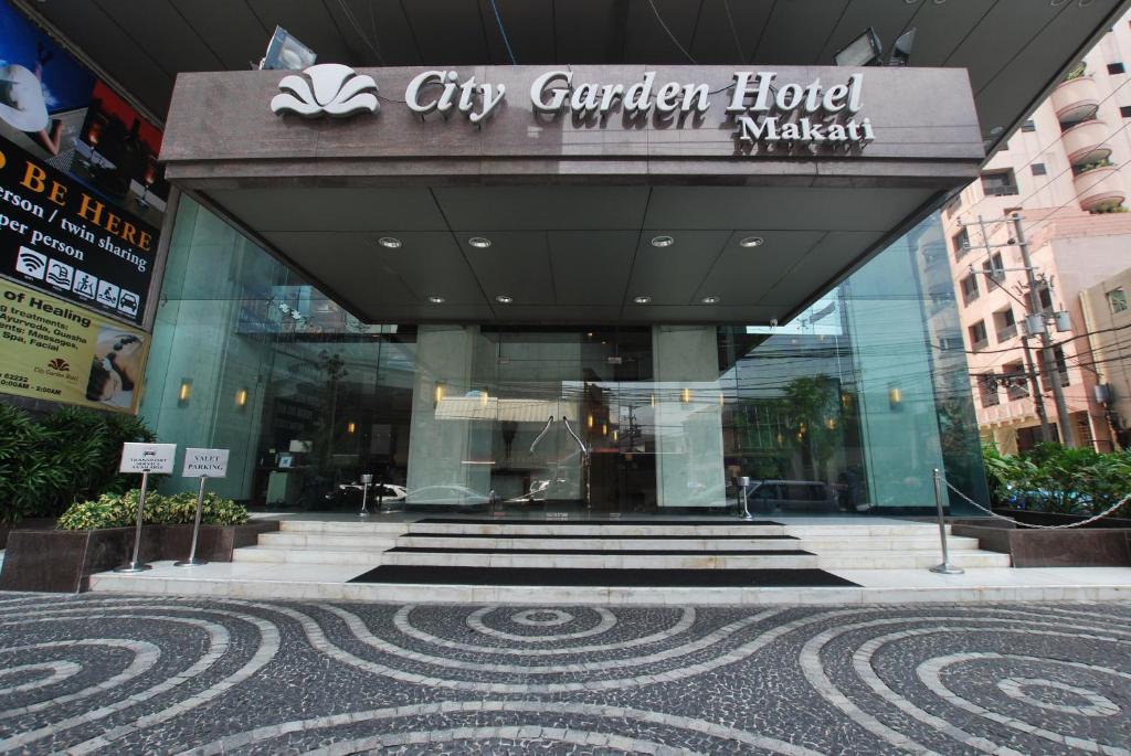 a large building with a sign on the side of it at City Garden Hotel Makati in Manila