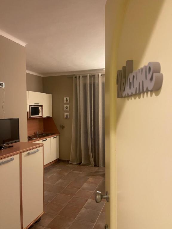 a kitchen with a door open to a room at Appartamento in centro Paese in Frabosa Soprana