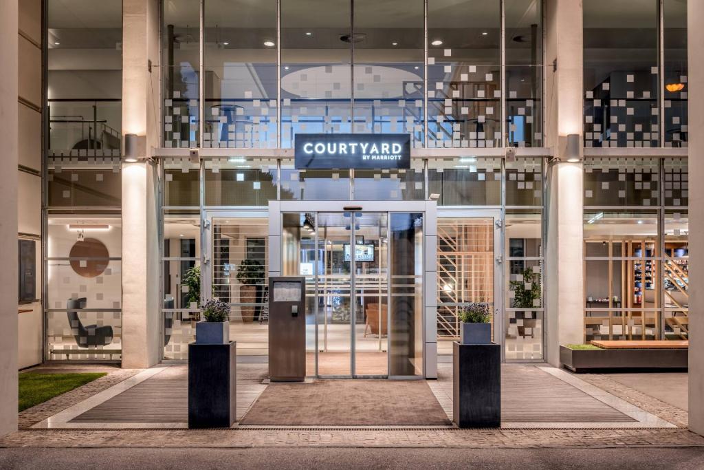 a lobby of a building with a revolving door at Courtyard by Marriott Linz in Linz