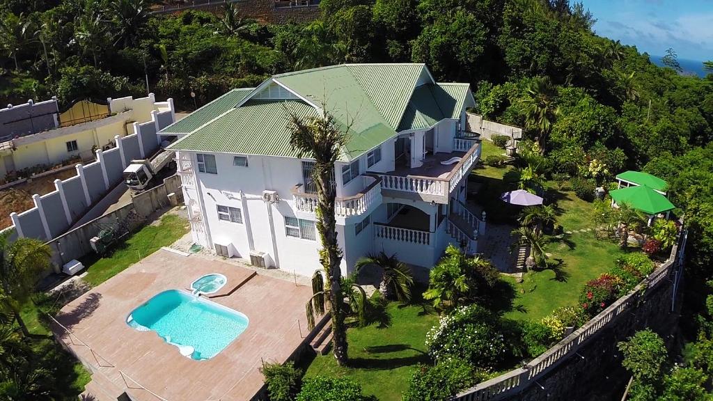 an aerial view of a house with a swimming pool at Villa Bel Age in Anse Royale