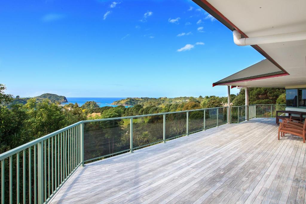 a deck with a view of the ocean at Tutukaka Dive Lodge in Tutukaka
