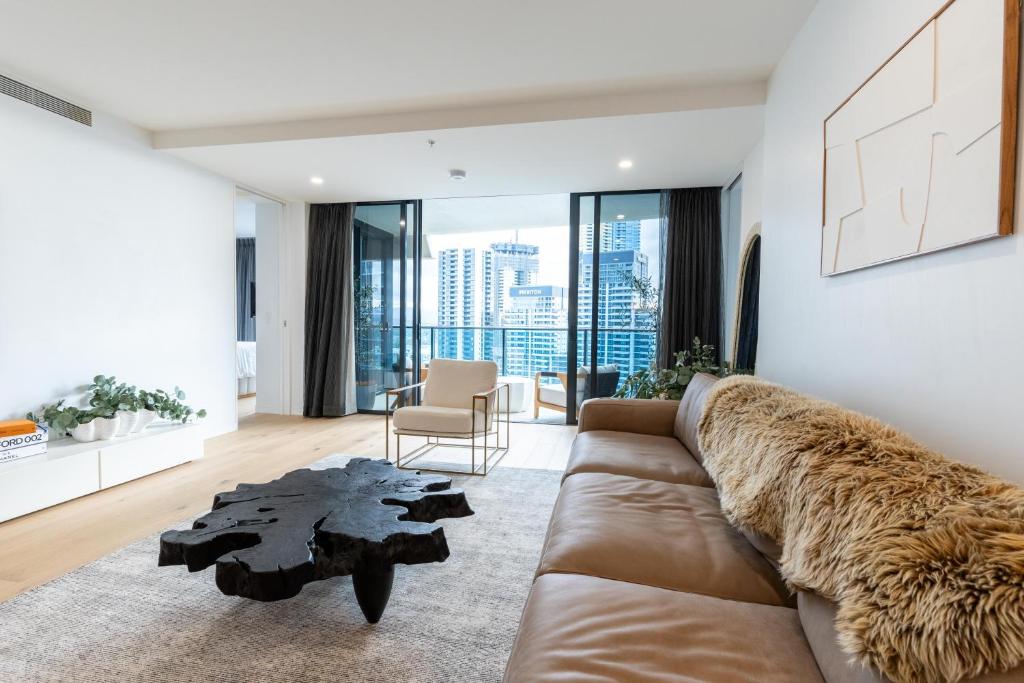 een woonkamer met een bank en een tafel bij Luxury Oracle Tower 1 Apartment 2Bed 2Bath 1 Car in Gold Coast