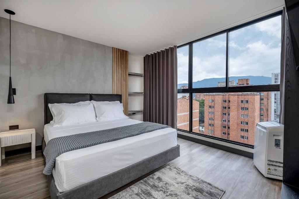 Postel nebo postele na pokoji v ubytování Apartamentos HOUSY Laureles