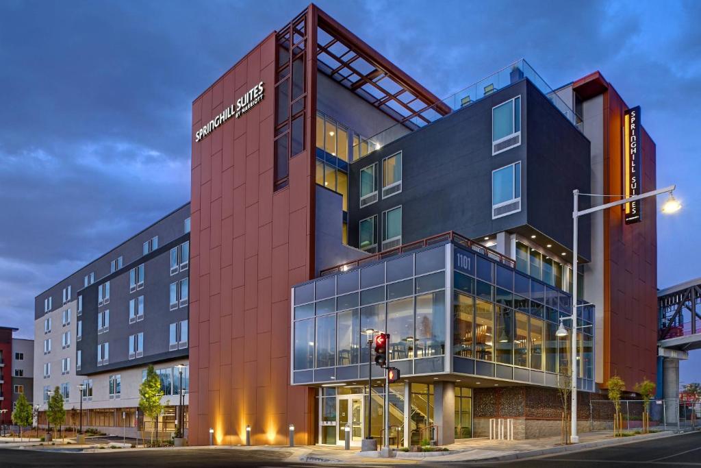 a building on the corner of a street with a traffic light at SpringHill Suites by Marriott Albuquerque University Area in Albuquerque