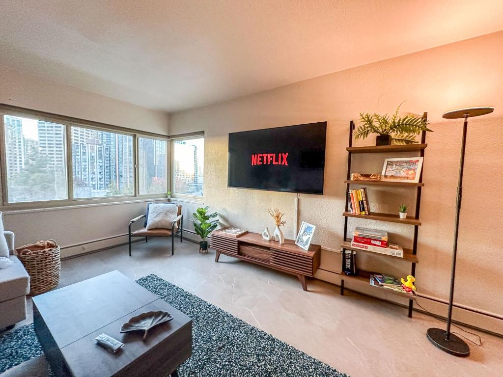 a living room with a tv on the wall at 2BR Downtown Convention Center Near Attractions in Seattle