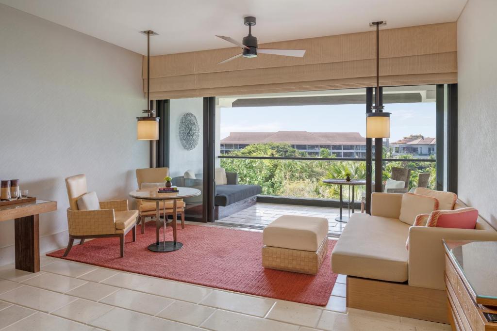 a living room with a couch and a table at The Ritz-Carlton Bali in Nusa Dua