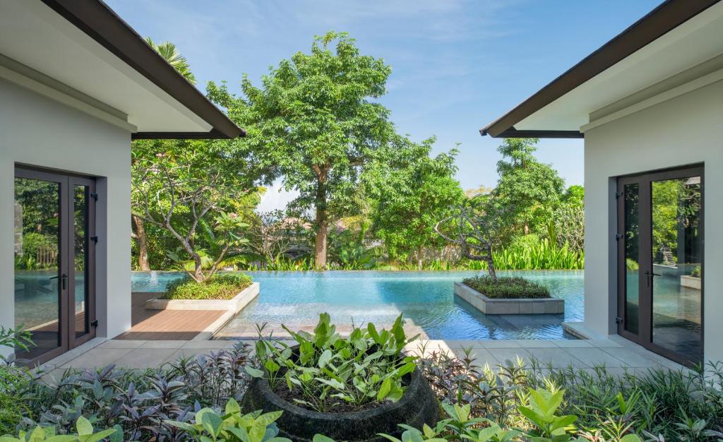 an external view of a swimming pool from a house at The Ritz-Carlton Bali in Nusa Dua