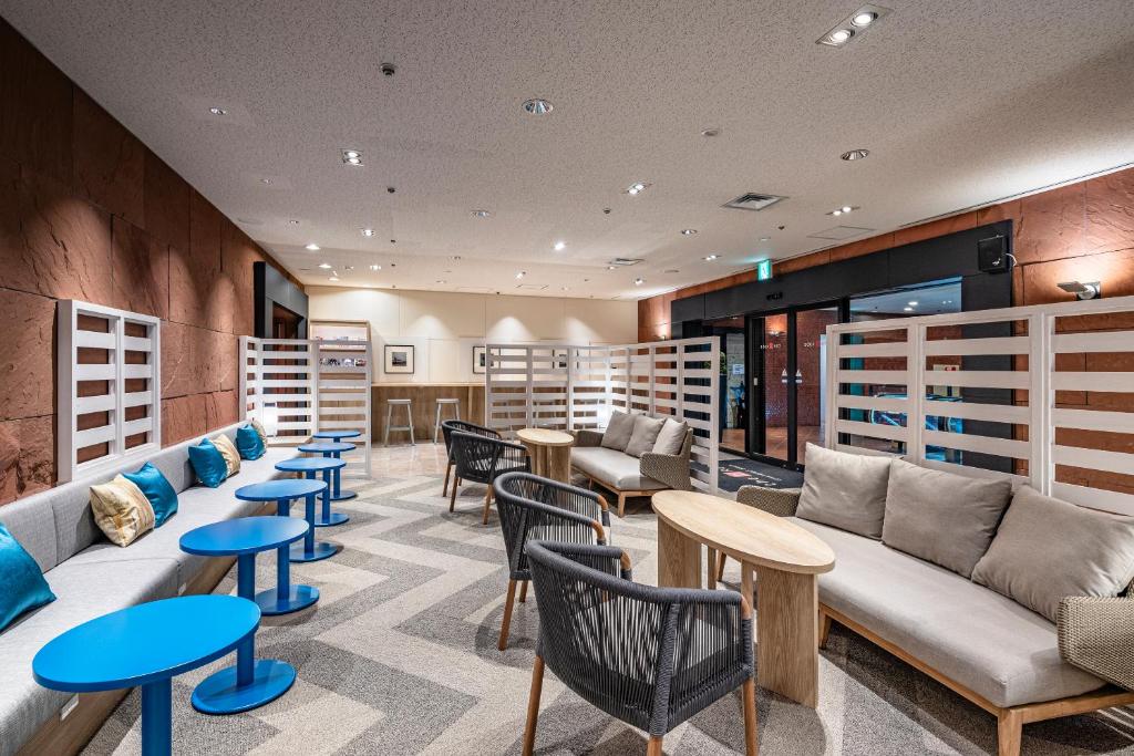 a library with couches and tables and chairs at the b kobe in Kobe