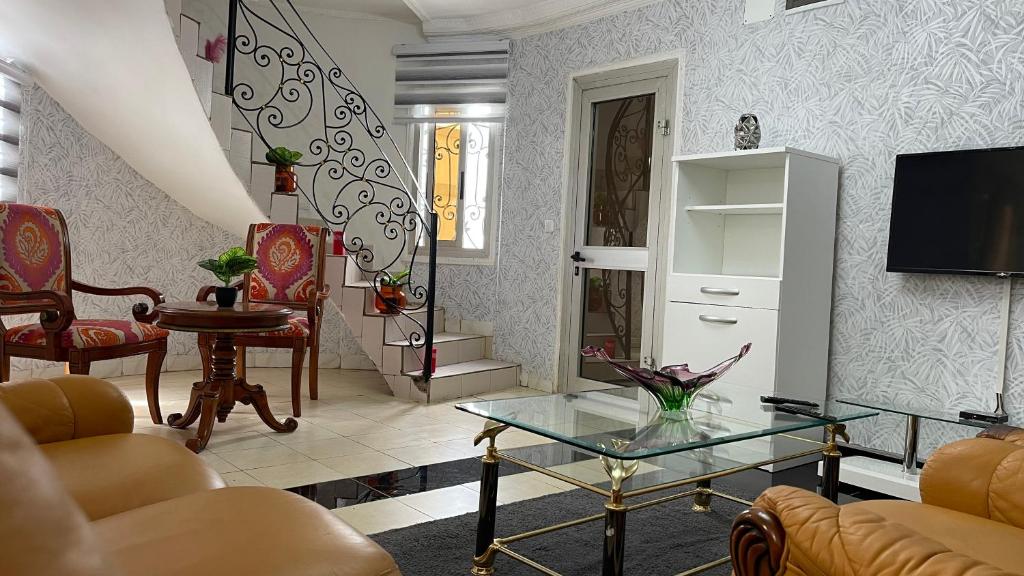 a living room with a couch and a table at PEACE GUEST HOUSE in Yaoundé