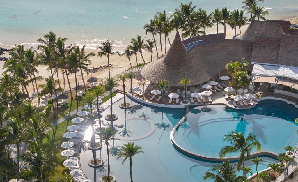 an aerial view of a resort with a swimming pool and the beach at LUX* Belle Mare Resort & Villas in Belle Mare