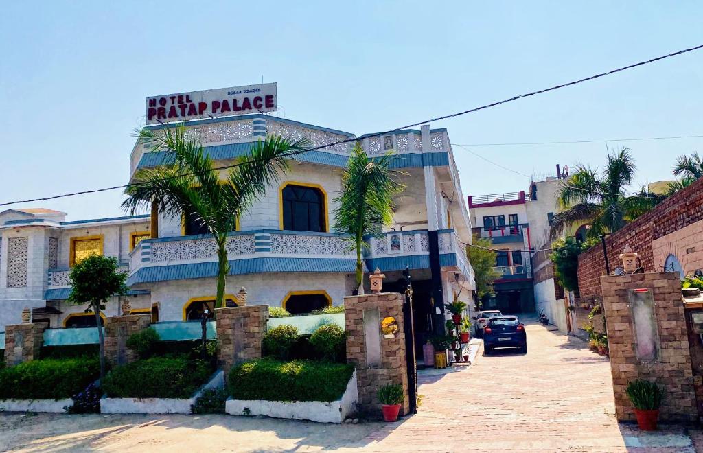 a building with a sign for a hotel at Hotel Pratap Palace in Bharatpur