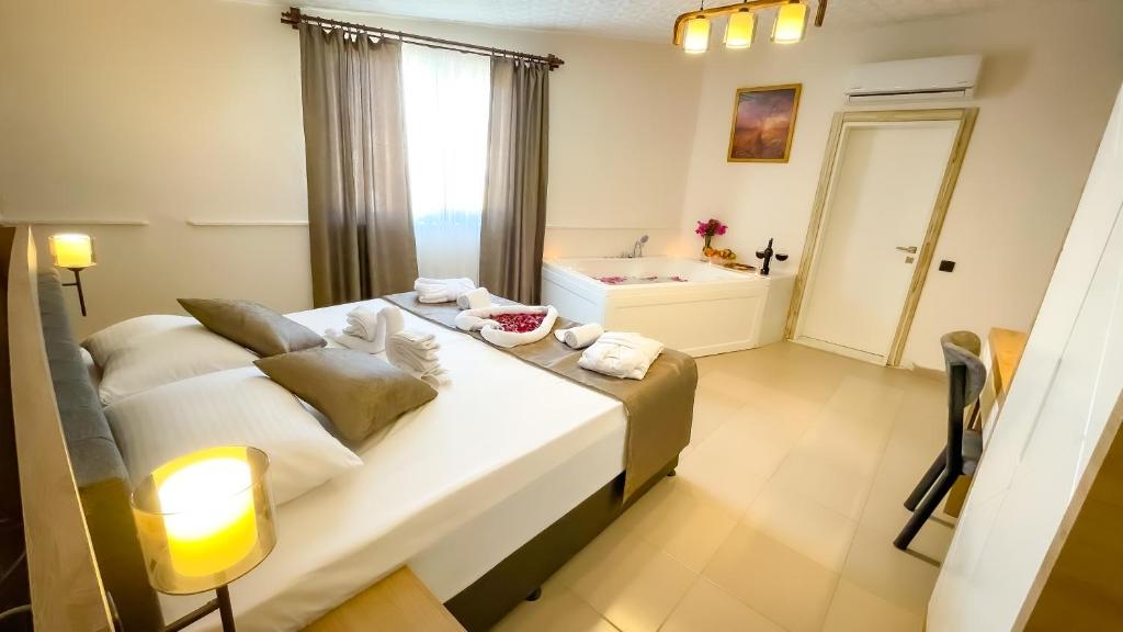 a bedroom with a large bed and a bathroom at Bloomtalya Hotel in Antalya