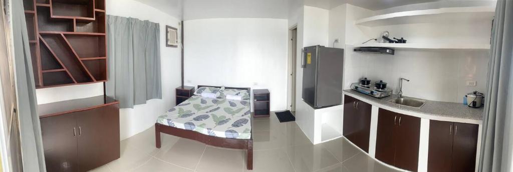 a small kitchen with a table and a sink at Angelito's Beach House Siargao in General Luna