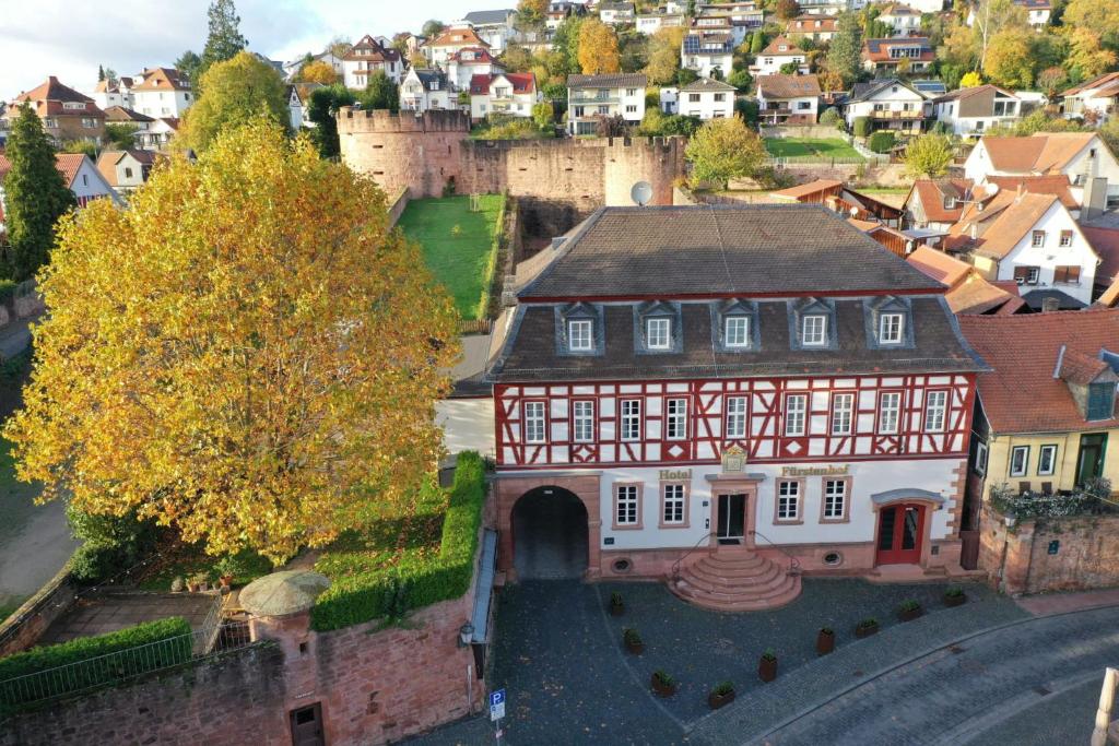 an aerial view of a building in a town with a castle at Hotel Fürstenhof in Büdingen