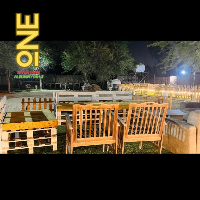 a group of wooden chairs and a table at ONE 7 FARM (DESI PARADISE FARM ) in Dubai