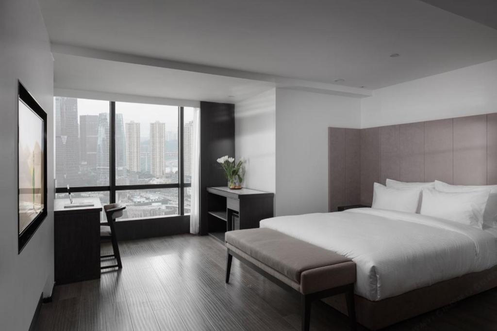 Postel nebo postele na pokoji v ubytování Jinxi Aerial Riverview Hotel - Chongqing Jiefangbei Hongya Cave