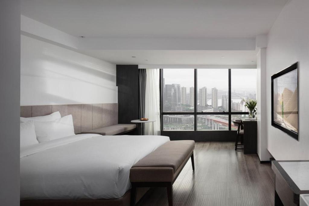 Postel nebo postele na pokoji v ubytování Jinxi Aerial Riverview Hotel - Chongqing Jiefangbei Hongya Cave
