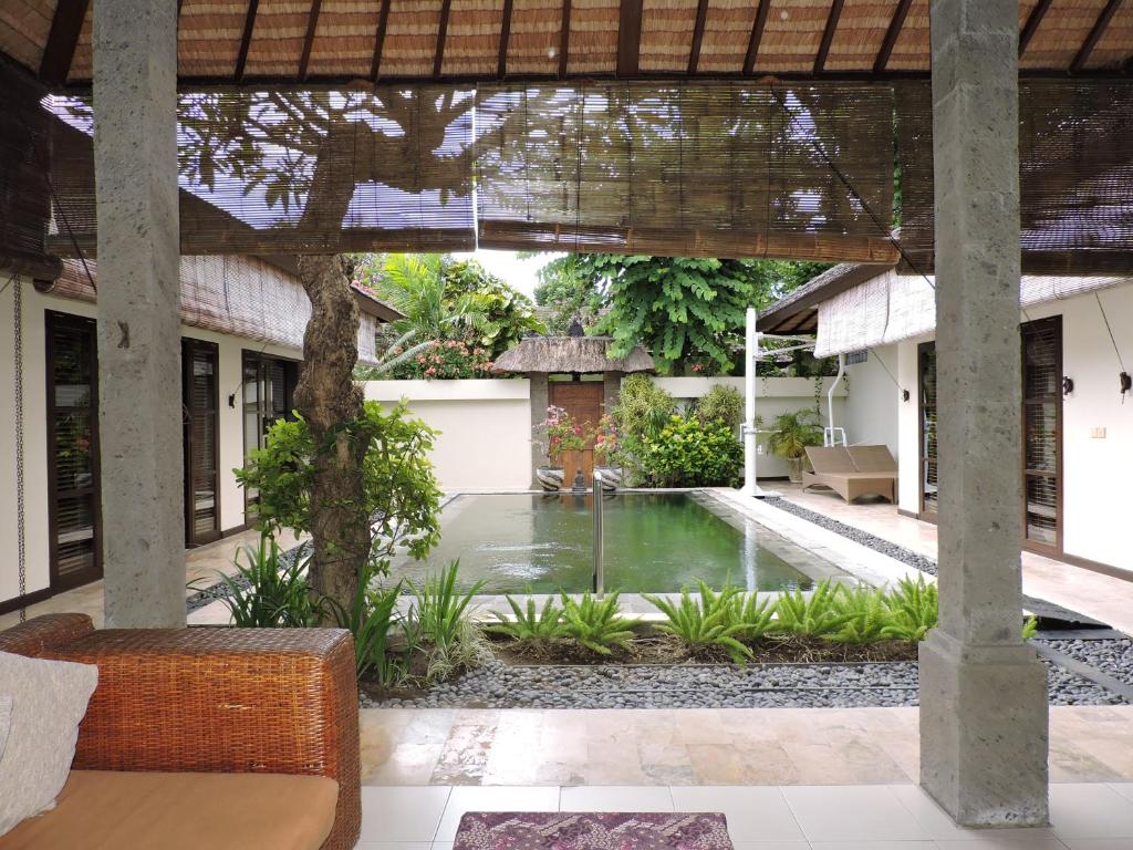 a courtyard with a pool in a house at Accessible Villa G in Sanur