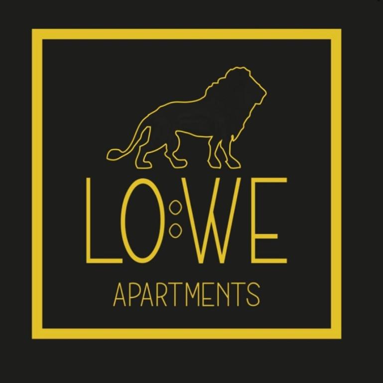 a sign with a lion and the words love experiments at Löwe Apartments in Oy-Mittelberg