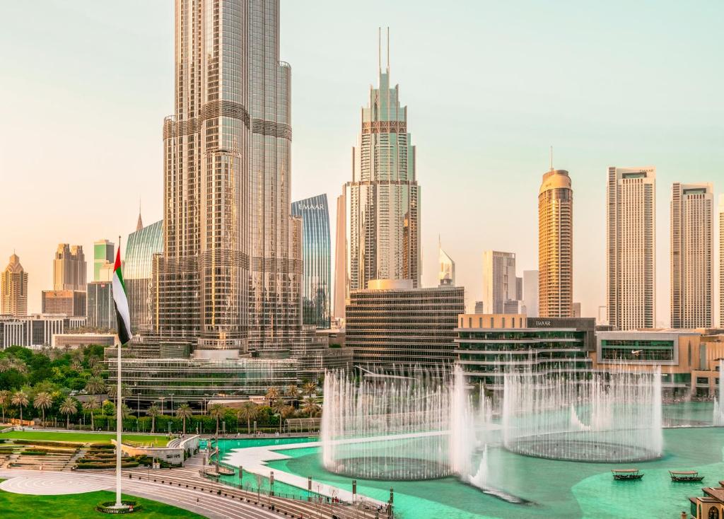 a city with a fountain in front of a city at Elite Royal Apartment - Full Burj Khalifa & Fountain View - Premier - 2 bedrooms & 1 open bedroom without partition in Dubai