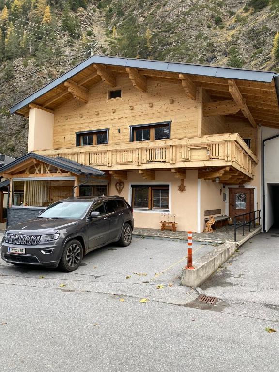 a car parked in front of a house at Haus Laterndl in Längenfeld