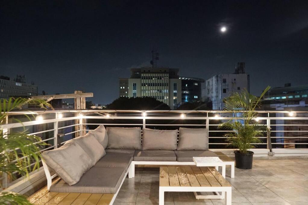 a couch sitting on top of a balcony at night at Spacious Comfy PH Apt for 9 @ San Juan - Miramar 4 - Nuevo in San Juan