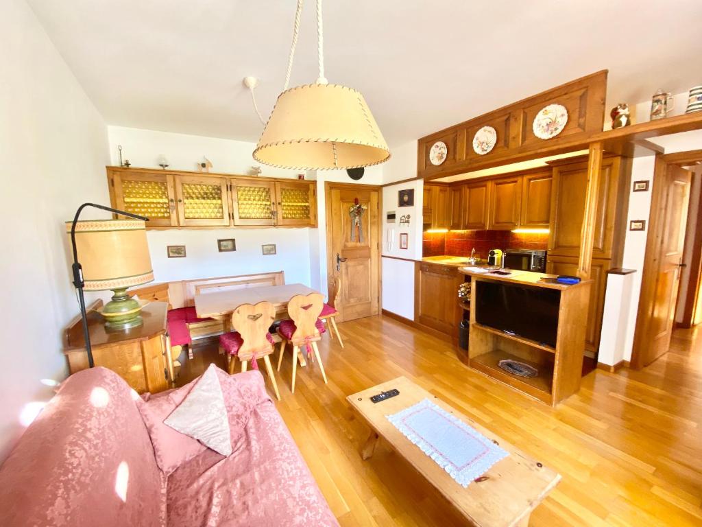 a living room with a couch and a table at FALORIA APARTMENT-splendid view in Cortina dʼAmpezzo