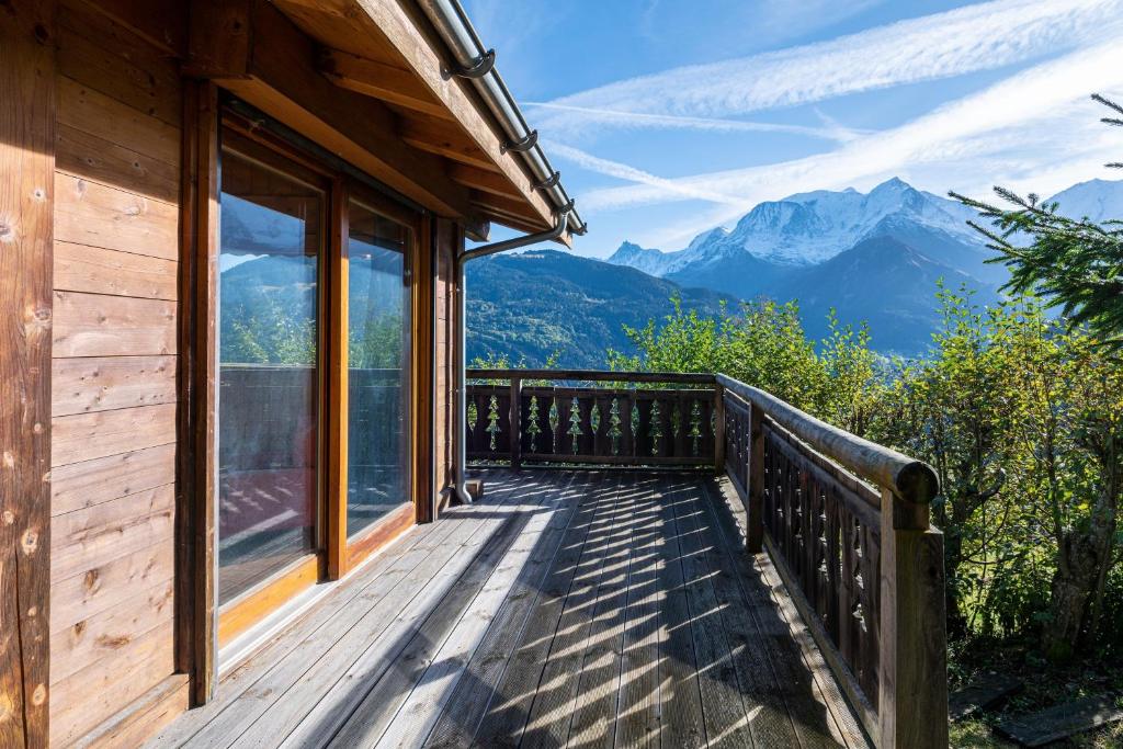 a wooden deck with a view of mountains at Le Relief - Maison avec magnifique vue montagne aux Bettex in Saint-Gervais-les-Bains