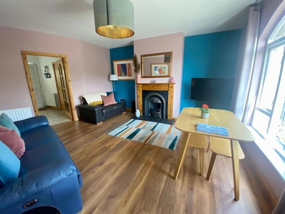 a living room with a couch and a table at Ballycastle Modern Town House in Ballycastle