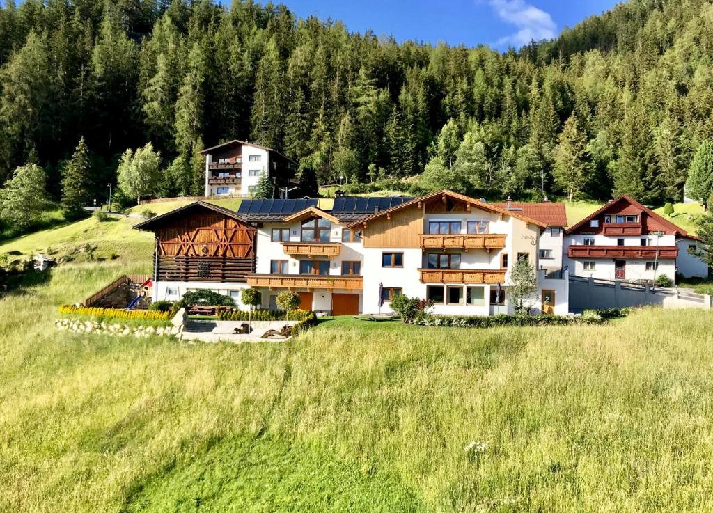 a large house on a hill in a field at Bergsonnhof in Jerzens