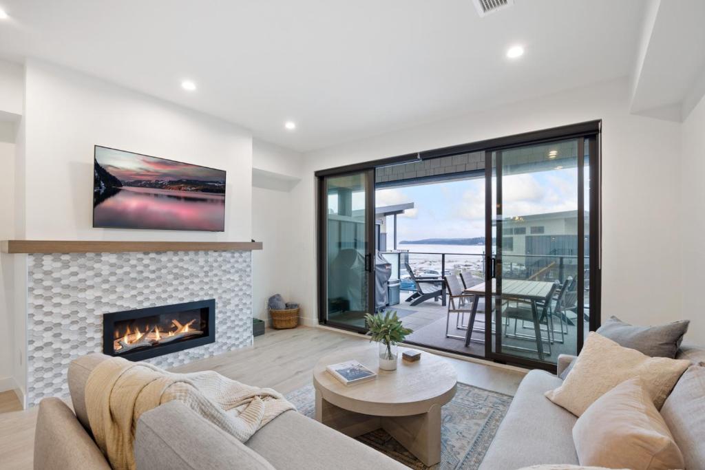 a living room with a couch and a fireplace at Coastal Haven at THE BEACH HOUSE in Campbell River