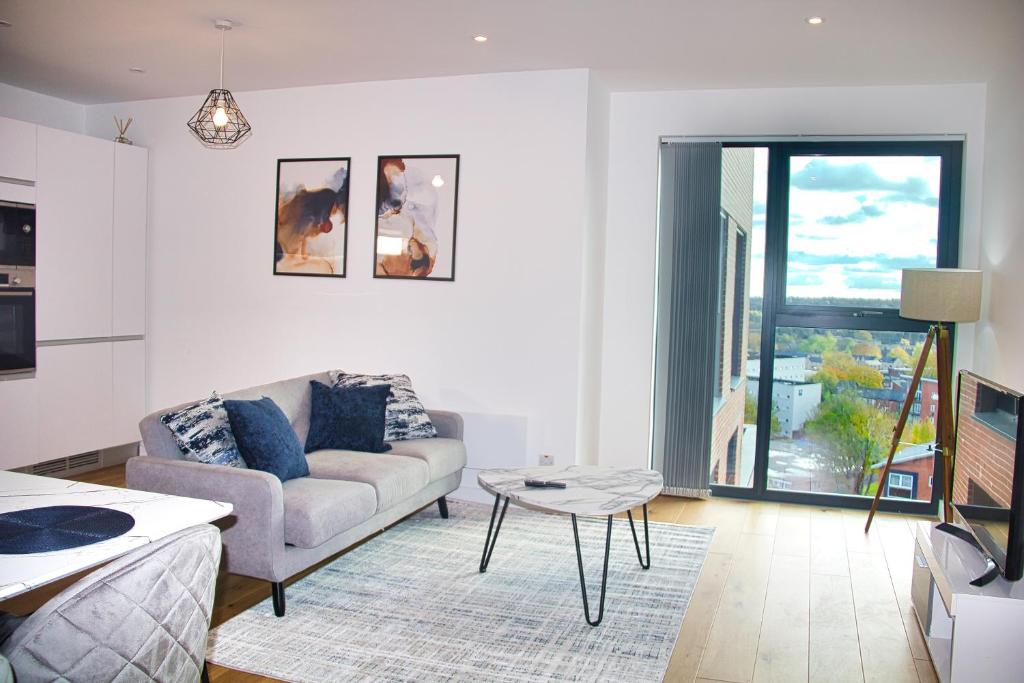 a living room with a couch and a table at AP- Luxury Apt nxt to o2 Academy in Birmingham