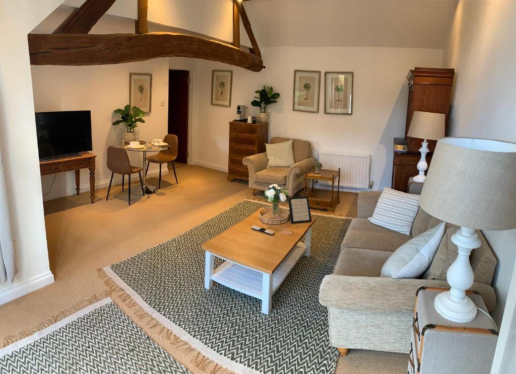 a living room with a couch and a table at The Byre in Abingdon