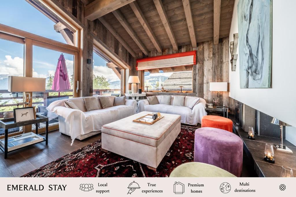 a living room with white furniture and large windows at Chalet Purdey Combloux - BY EMERALD STAY in Combloux