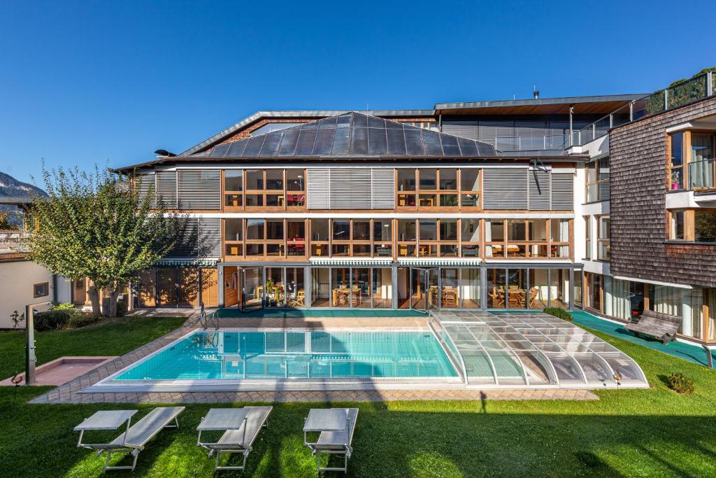 a large house with a swimming pool in front of it at Martinshof in Sankt Johann in Tirol