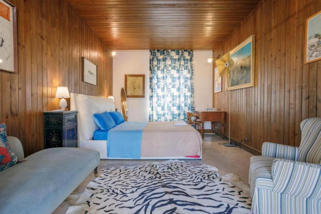 a bedroom with a bed and a zebra rug at Artists penthouse in Palermo