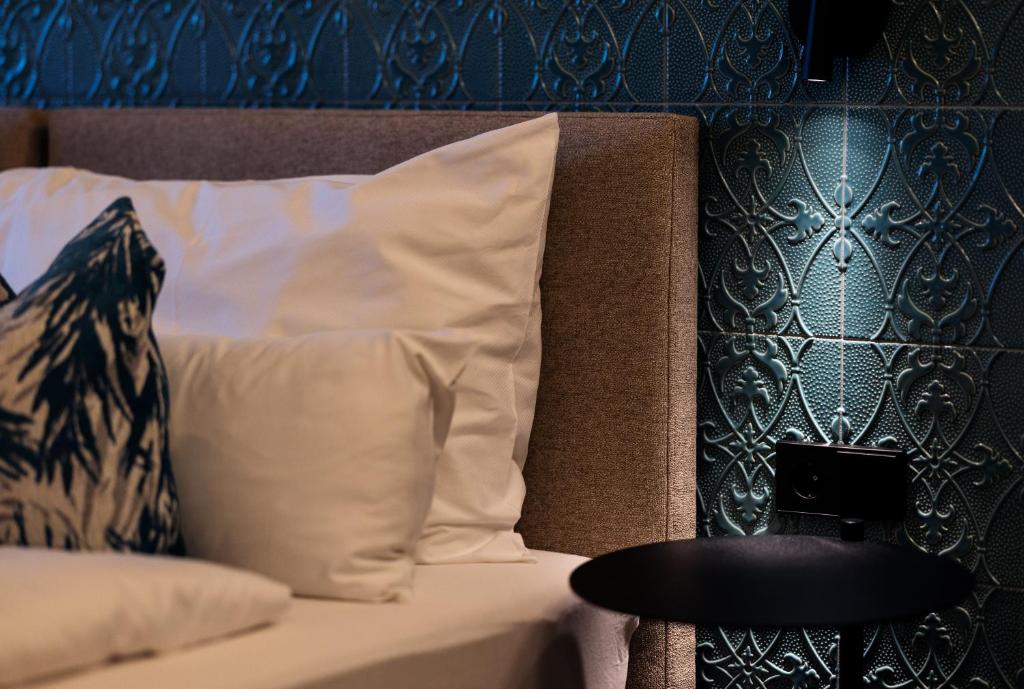 Postel nebo postele na pokoji v ubytování Hafnerhotel - Das Kachelofen-Wohlfühlhotel