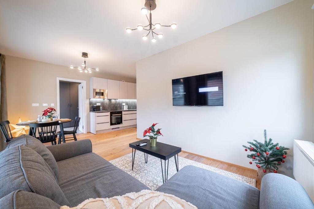 a living room with a couch and a table at Trio Harrachov in Harrachov