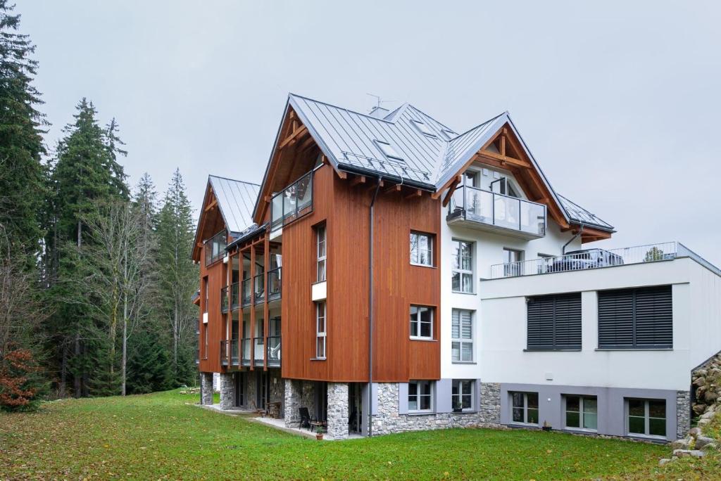 a large house with a gambrel roof at Trio Harrachov in Harrachov