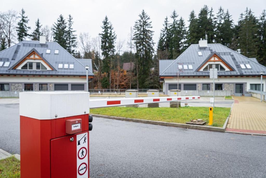a red and white gas station in front of houses at Trio Harrachov in Harrachov
