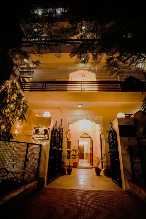 a hallway of a house with a gate and plants at KARNI VILAS in Jaipur