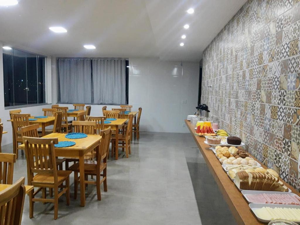 a dining room with wooden tables and chairs at Pousada Vale do Sol Capitólio in Capitólio