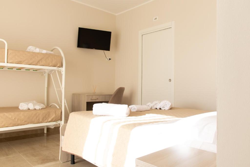 Postel nebo postele na pokoji v ubytování Bed & Breakfast Nonno Gigi - Falerna Marina