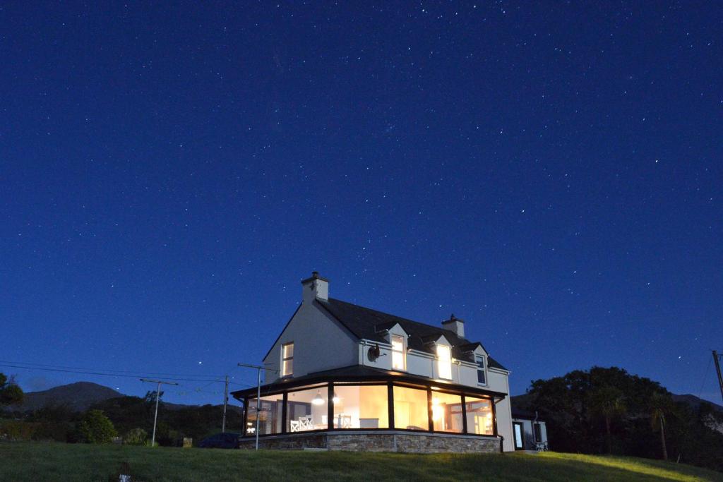 a house at night with its lights on at Casey House in Castletownbere