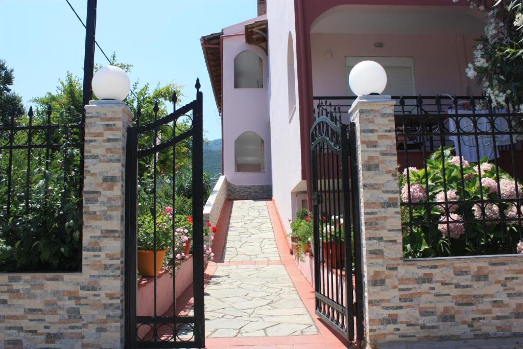 a gate to a house with a walkway at Sunray Studios in Stavros
