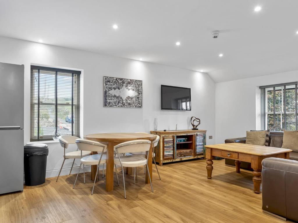 a living room with a wooden table and chairs at Pass the Keys 3 bed Cottage Above Beautiful Country Pub in Baycliff