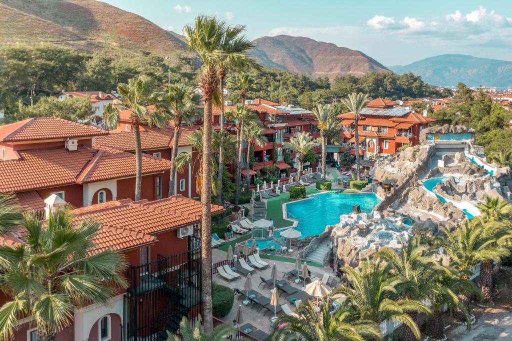 an aerial view of a resort with a pool and palm trees at Grand Aquarium in Marmaris